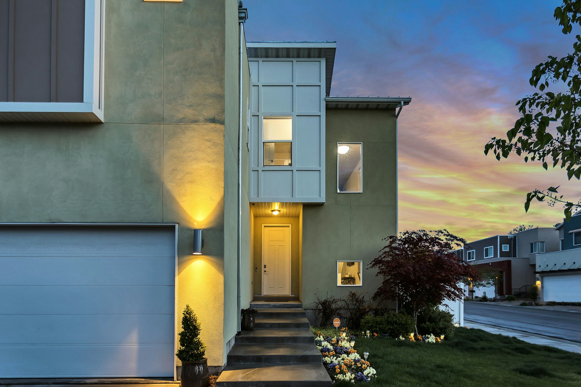 Residential home exterior lit at dusk